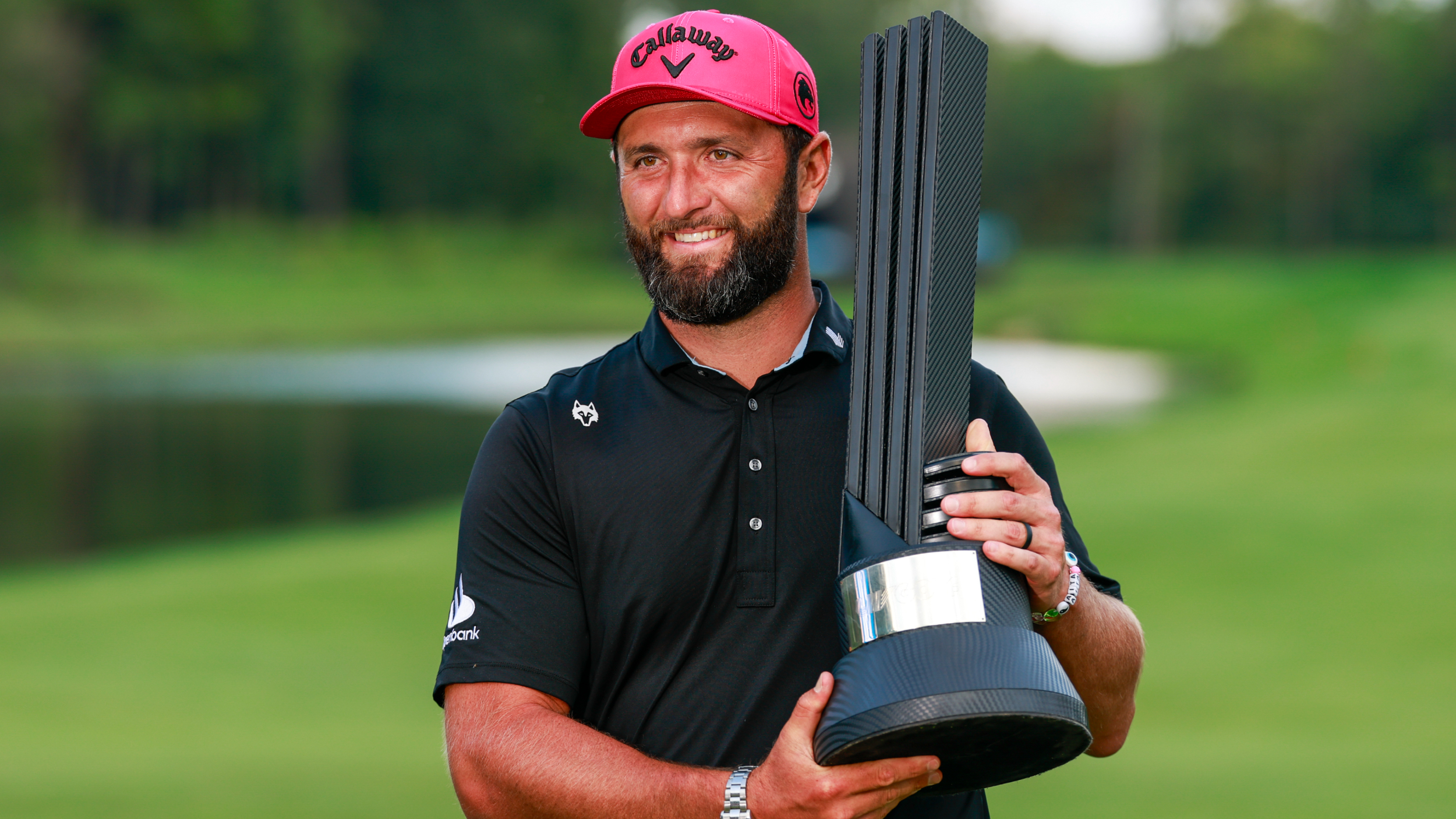 Jon Rahm with the individual championship trophy