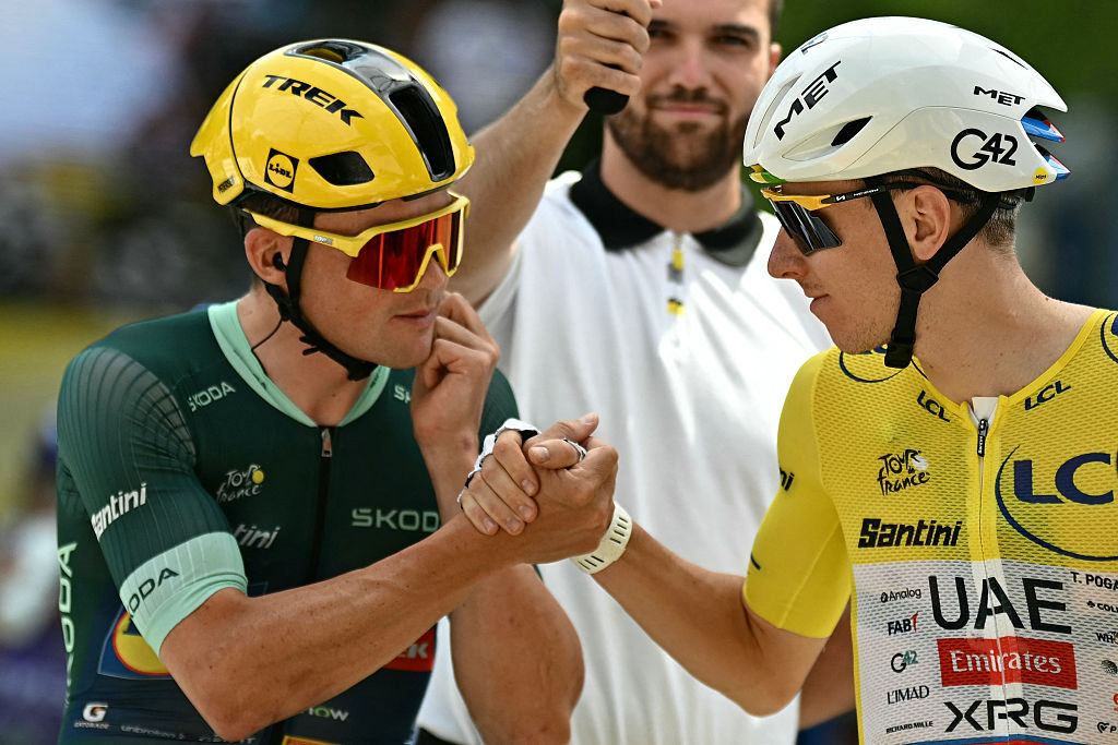 Lidl - Trek team's Danish rider Mads Pedersen wearing the sprinter's green jersey shakes hands with UAE Team Emirates - XRG's Slovenian rider Tadej Pogacar wearing the overall leader's yellow jersey at the start of the 13th stage of the 113th edition of the Tour de France cycling race, 205,8 km between Dole and Belfort in eastern France, on July 17, 2026. (Photo by Loic VENANCE / AFP)
