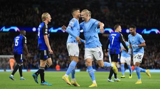 Manchester City's Erling Haaland celebrates with teammate Joao Cancelo after scoring his team's first goal in the UEFA Champions League match between Manchester City and FC Copenhagen on 5 October, 2022 at the Etihad Stadium, Manchester, United Kingdom