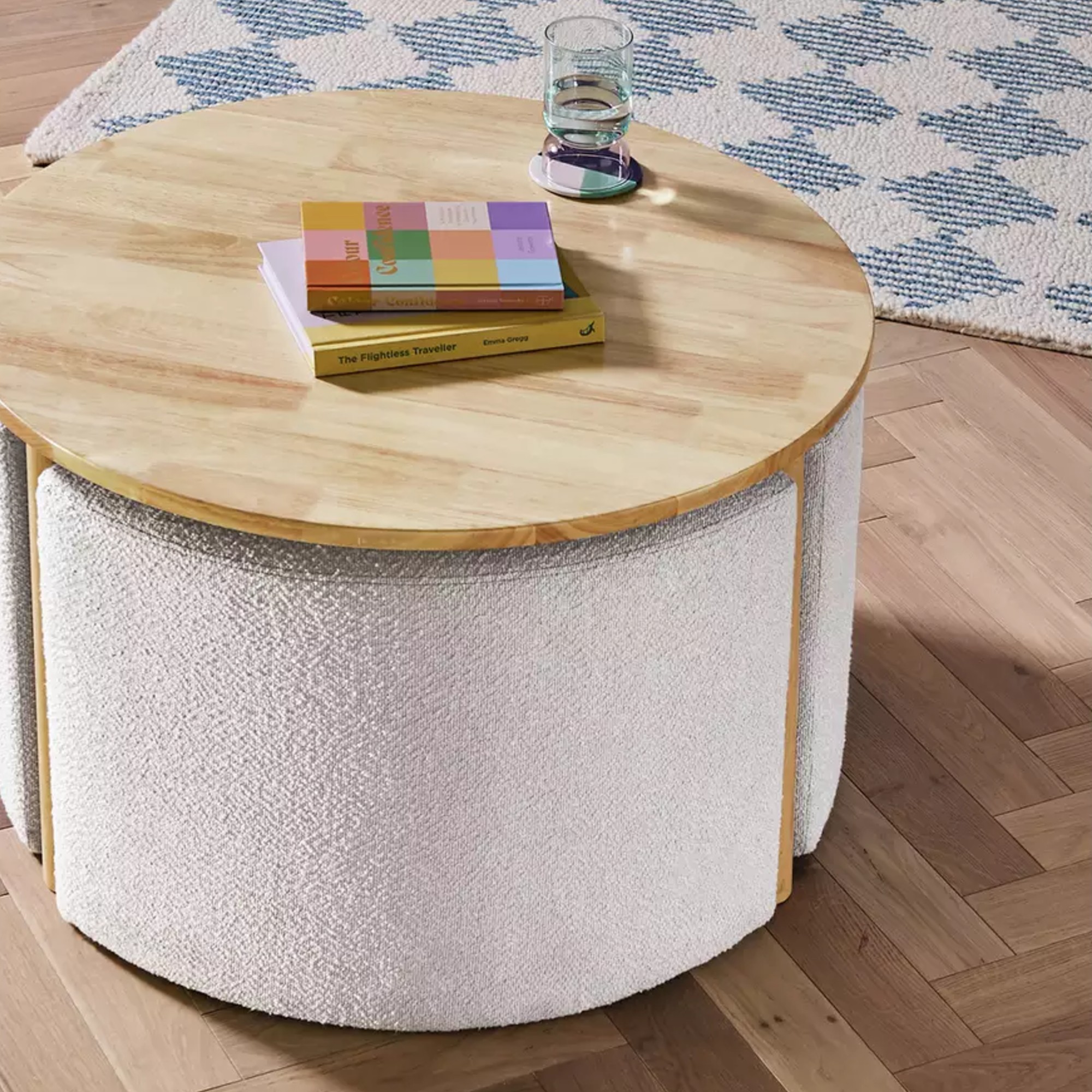Habitat Harriet Coffee Table with tucked-in accompanying pouffes with a diamond-pattern rug in the background