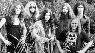 Lynyrd Skynyrd standing in tall grass