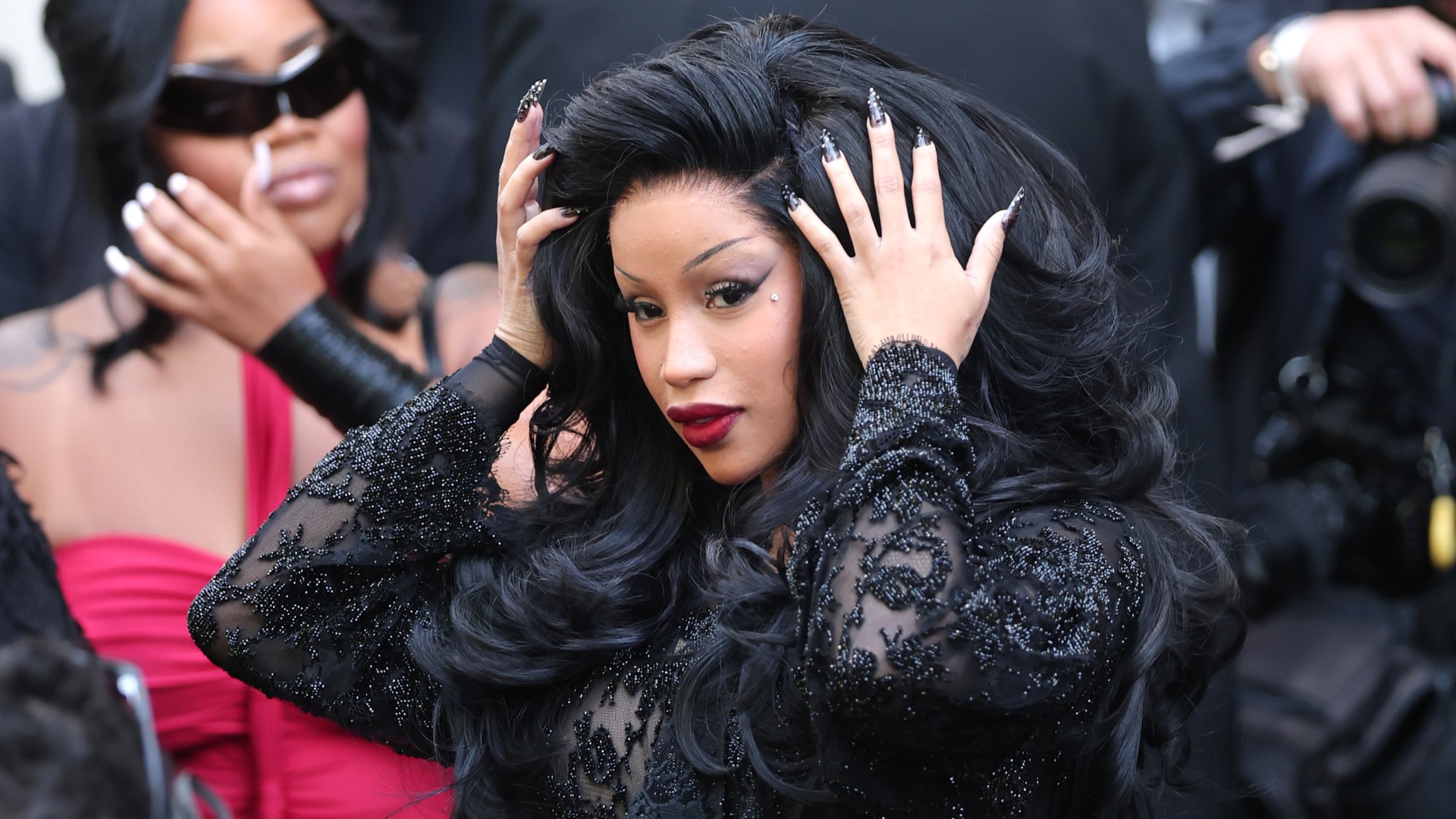 Cardi B wearing a black lace dress