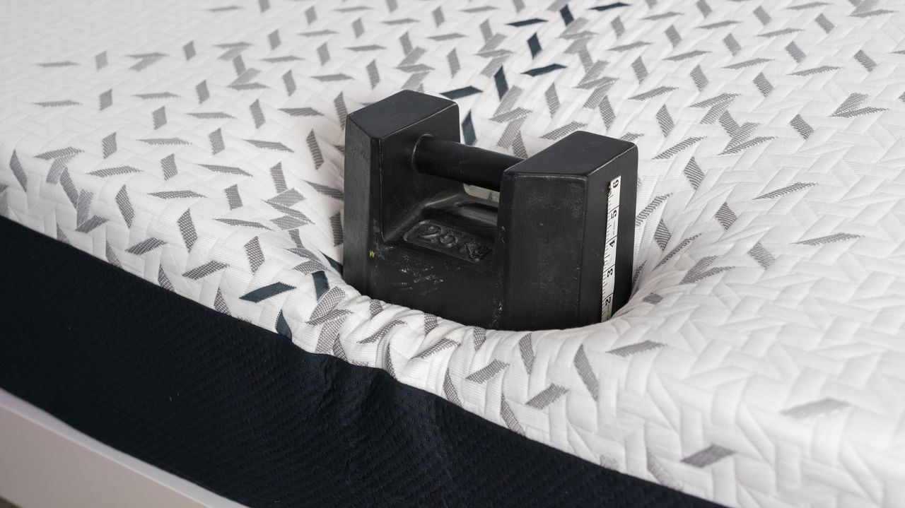A weight on the edge of the Nectar Luxe mattress to test edge support