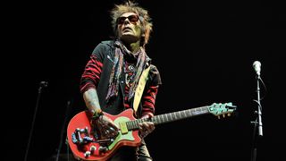 Earl Slick of New York Dolls performs on stage at Alexandra Palace on October 29, 2011 in London