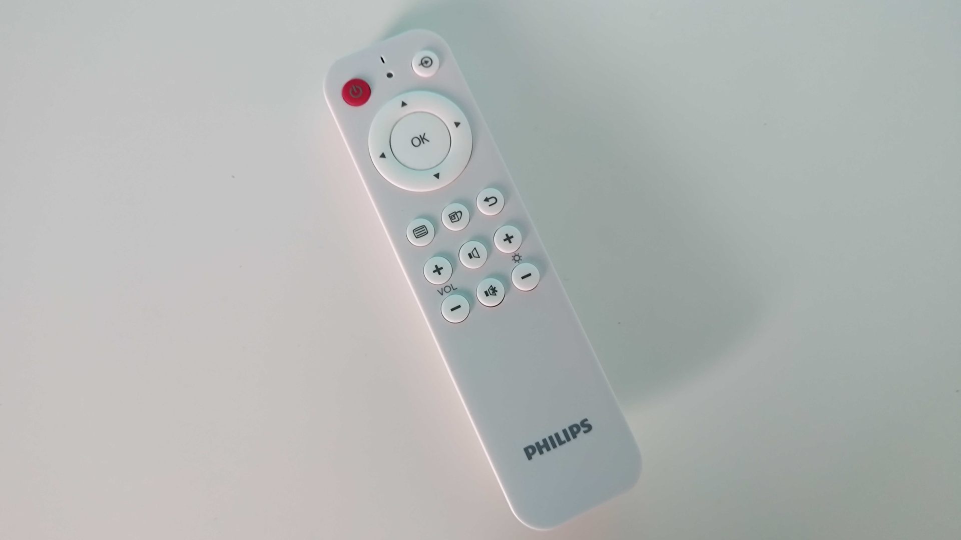 Philips Evnia 42M2N8900 remote on white desk