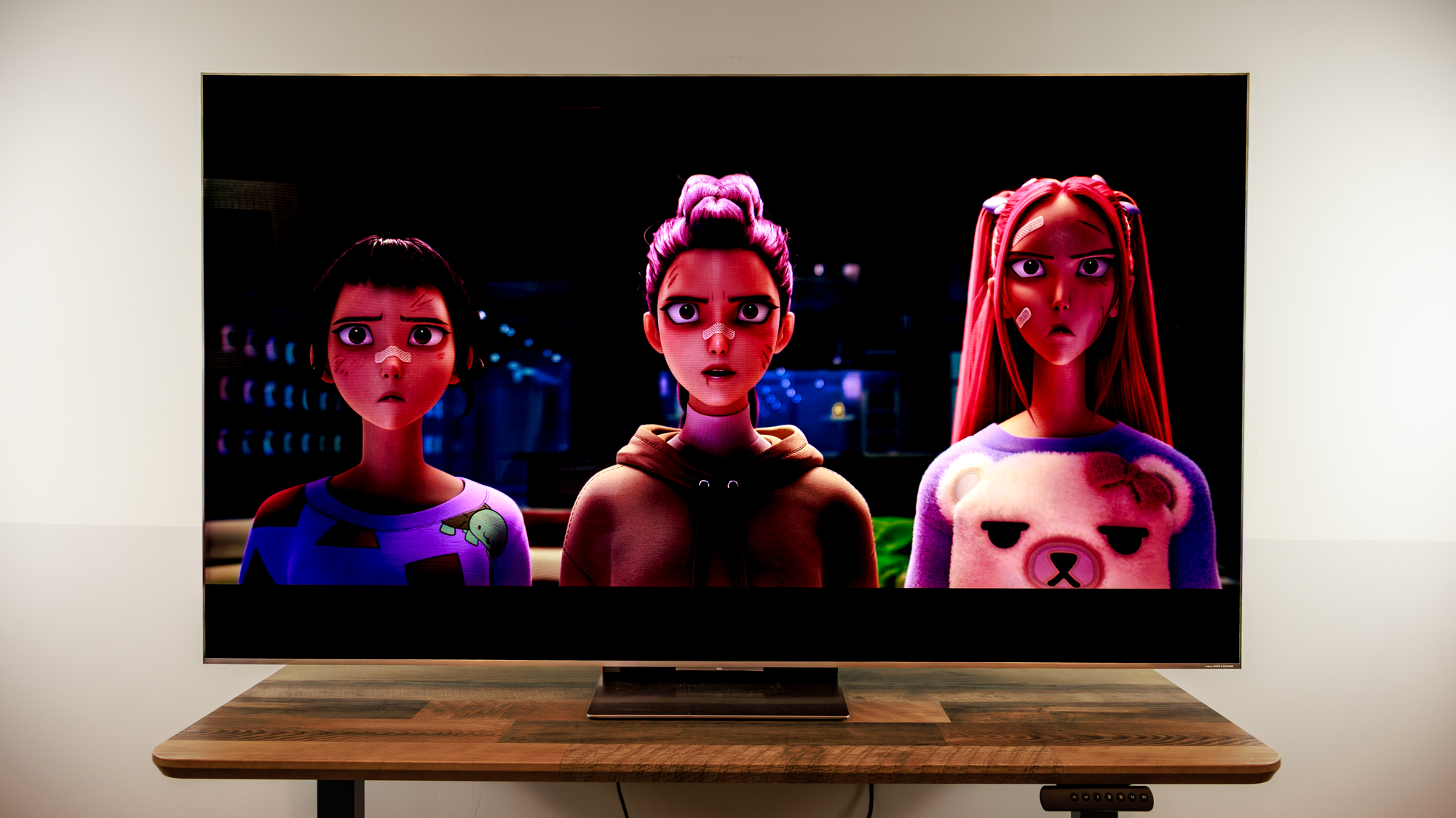 A 75-inch TCL QM8L TV on a desk