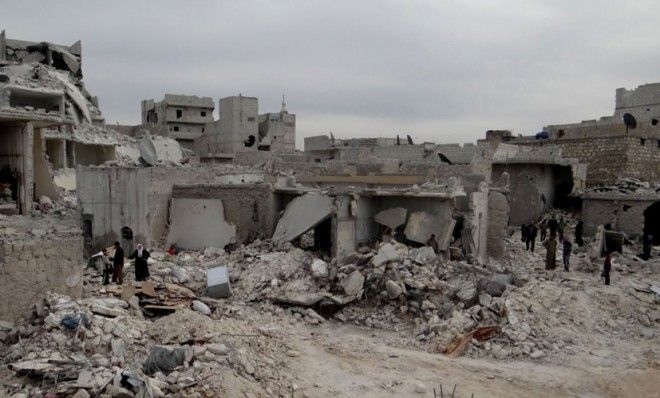 Syrian citizens inspect the desolated site of a government airstrike in Aleppo on March 19.