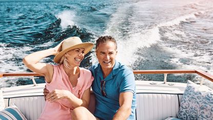 A mature, wealthy, retired couple on a boat