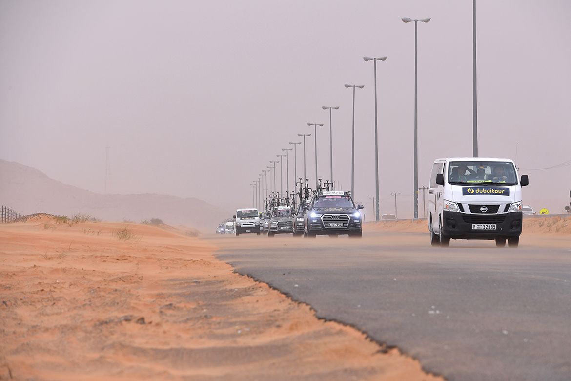 Wind blows sand over the road