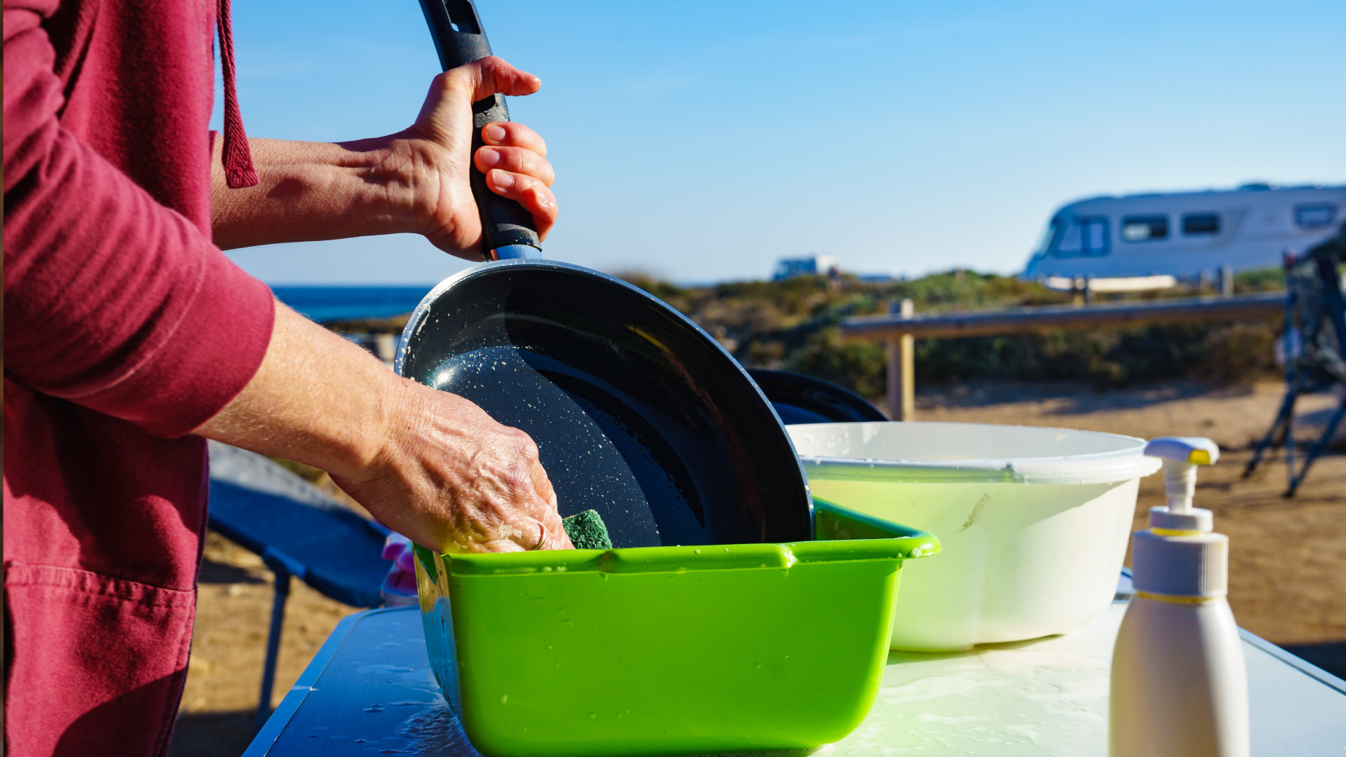 A person washing up on their camping trip