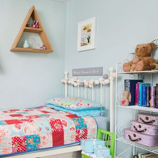 children room with bed and books