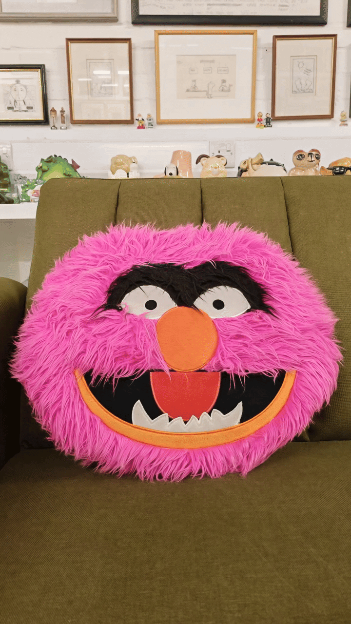 Animated gif of muppets character cushion rocking on a sofa