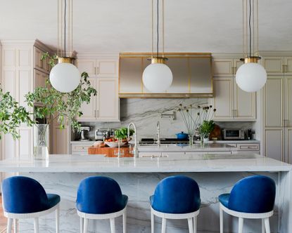 Grey and white kitchen ideas with grey cabinets, white island and bright blue bar stools