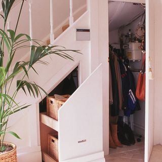 room with white staircase and plant in pot