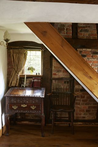 wooden furniture under the stairs in cottage
