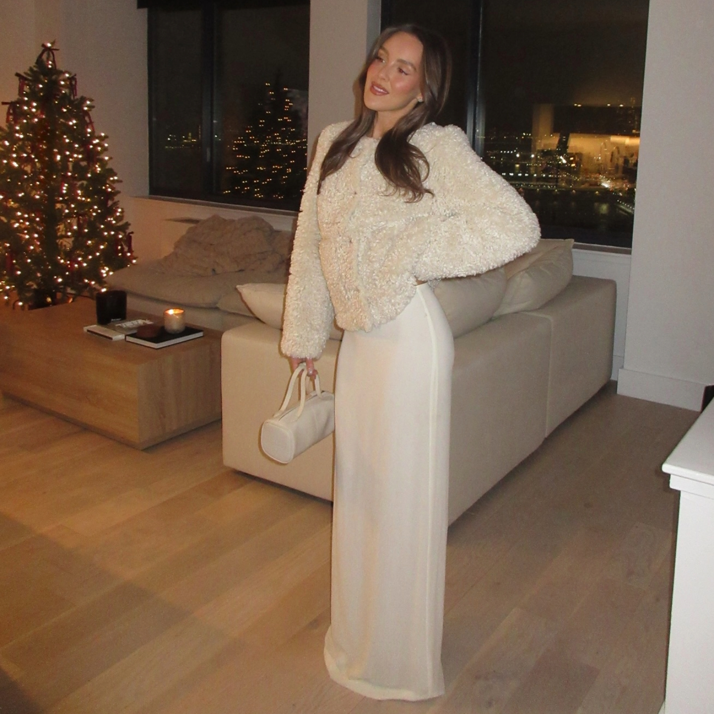 Emma Leger in a white fur coat and maxi skirt