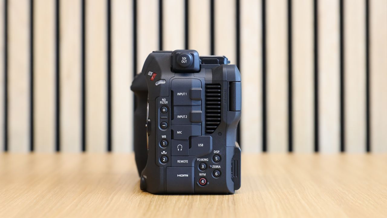 Canon EOS C80 cinema camera on wooden desk with wooden paneling behind