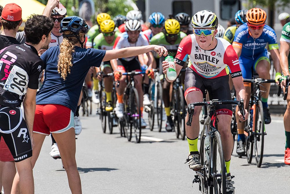 Riders get hand ups during today's long crit.