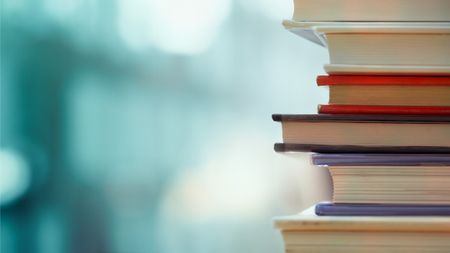 A stack of books on a table.