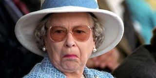 Queen Elizabeth with a repulsed look on her face.