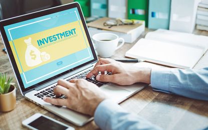 laptop screen with the words investment concept on it