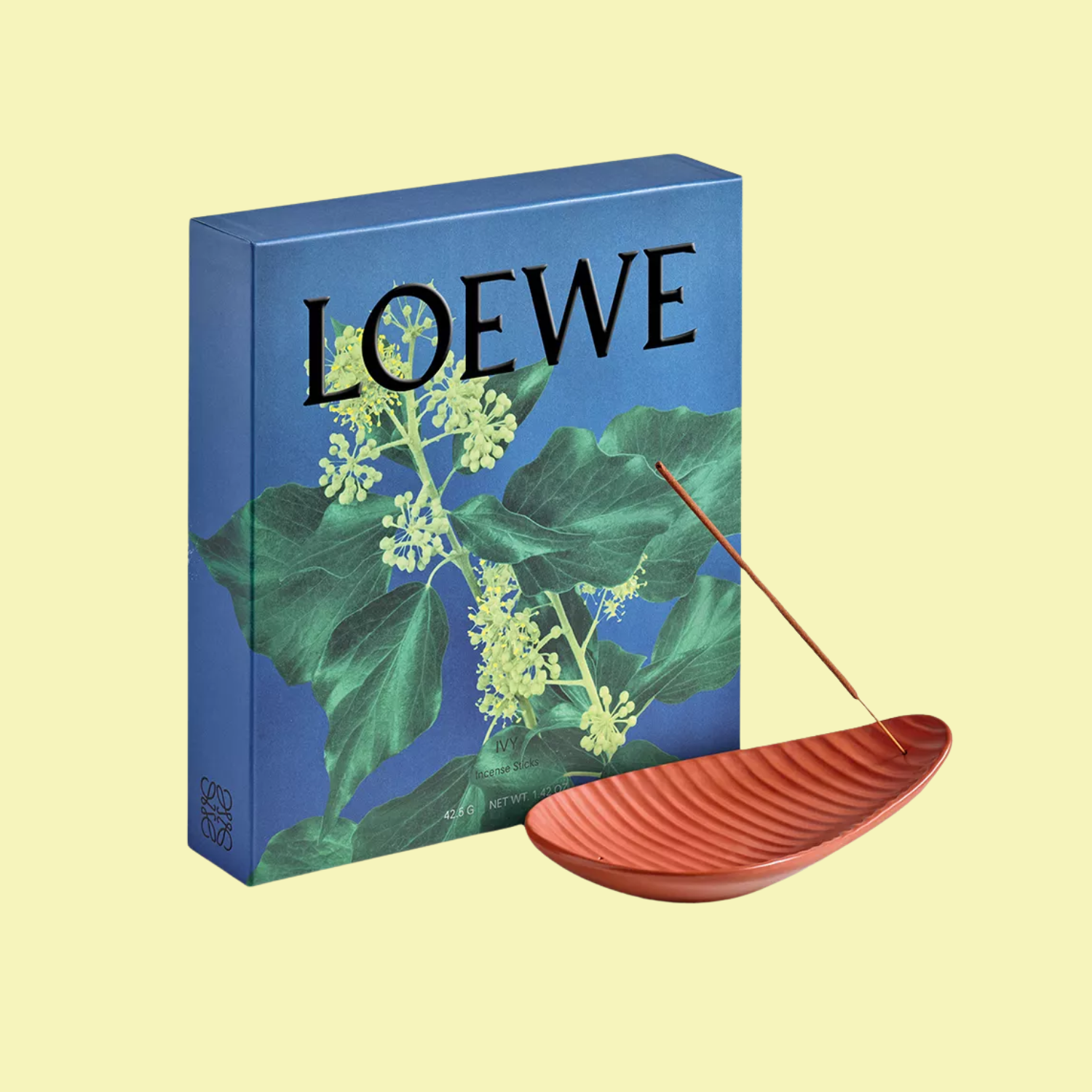 A blue box with an ivy print and a terracotta incense holder