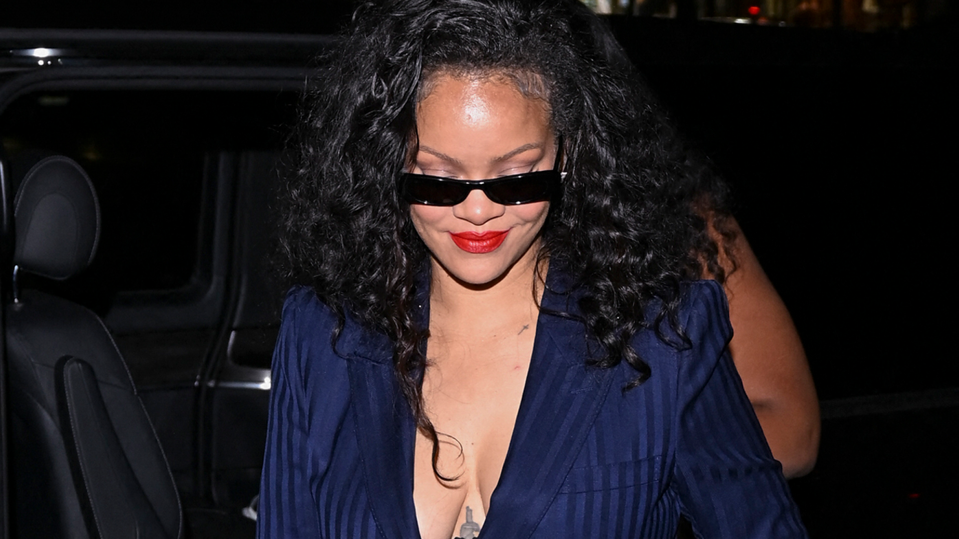 Rihanna wore the peekaboo bra trend with a pinstripe suit and a bedazzled Dior bag at C&eacute;line Dion's concert in Paris