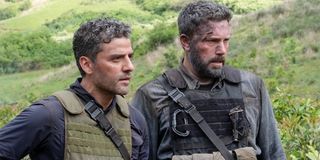 Triple Frontier Oscar Isaac and Ben Affleck surveying a situation in the jungle intensely