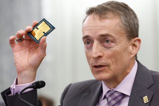Intel CEO Pat Gelsinger holds up a semiconducting chip during a Senate hearing on technology in March 2022 
