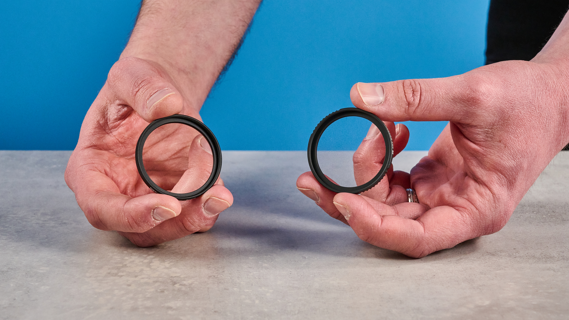 A photo of a K&amp;amp;F CONCEPT Mist Filter and a Neewer Mist Filter in hand