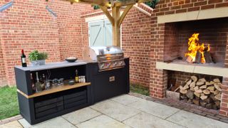 outdoor kitchen with bbq and open fire