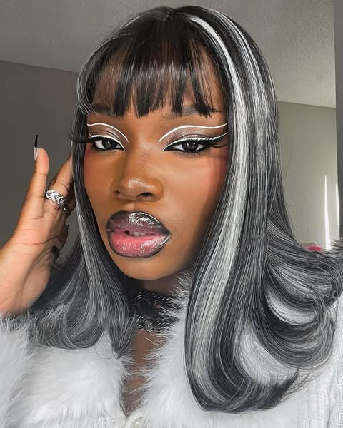 A woman wearing floating black and white graphic liner.
