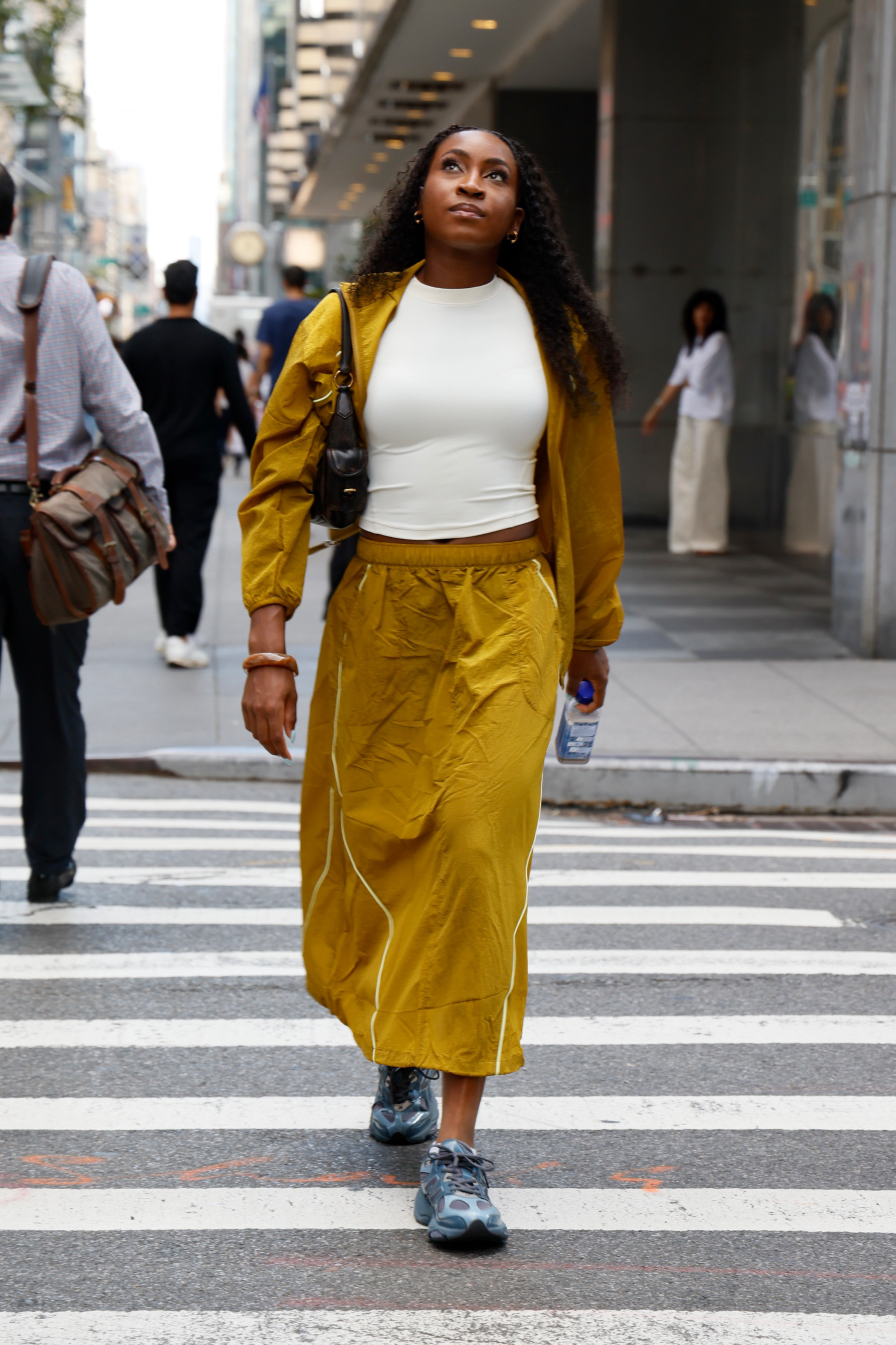 Coco Gauff's track skirt pulled off the mustard yellow color trend for fall with New Balance sneakers