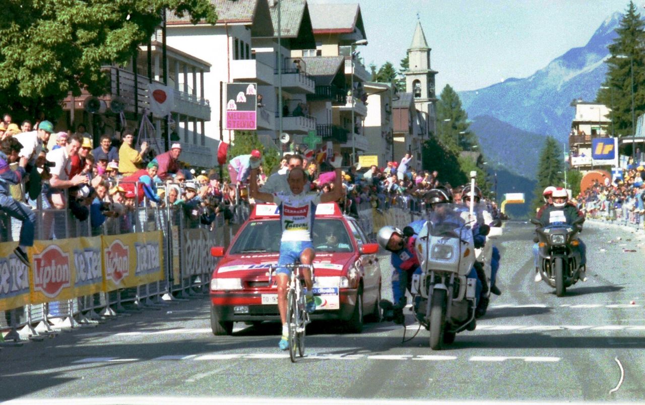 Pantani raises his arms as he crosses the line