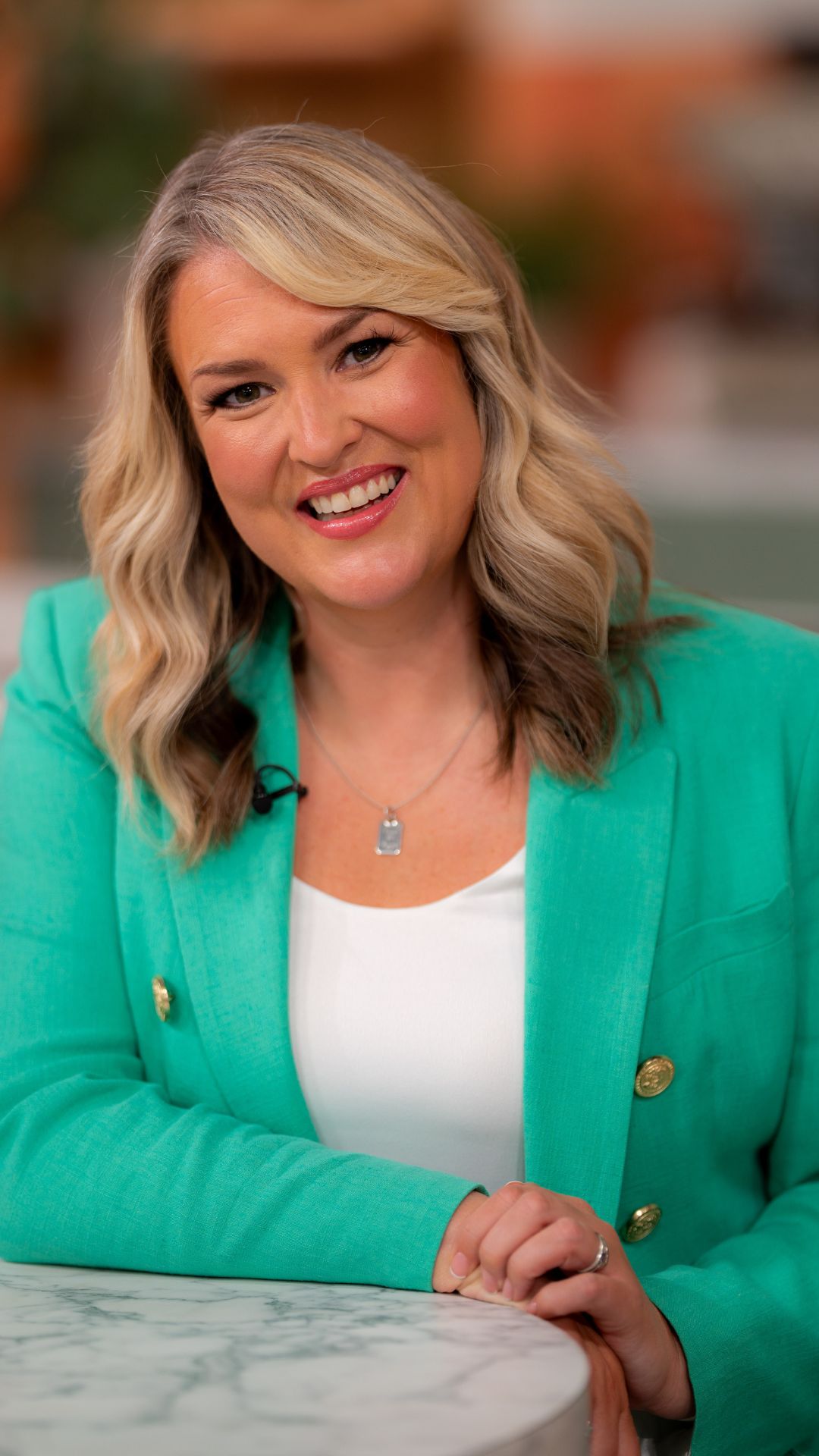 sara davies wearing a turquoise blazer