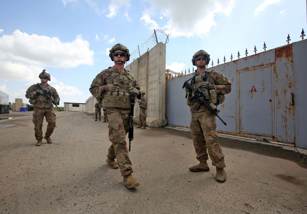 US army soldiers, part of the Combined Joint Task Force Operation Inherent Resolve (CJTF-OIR) the US-led coalition against the Islamic State (IS) group, walk around at the K1 Air Base northwe