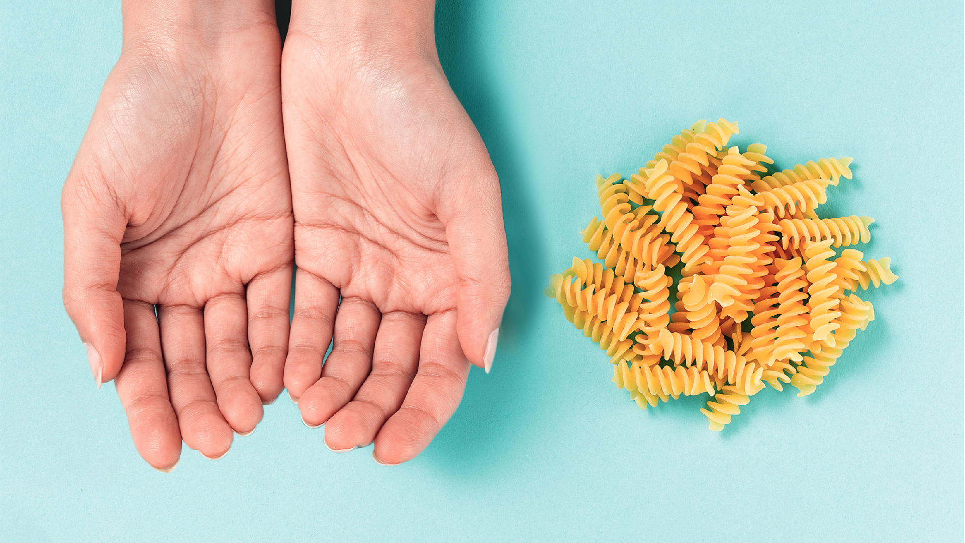 hands next to portion of pasta