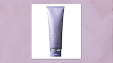 A close up of the Kate Somerville Goat Milk Moisturising Cleanser in a pastel purple, textured template