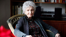 Alice Munro sits in a chair