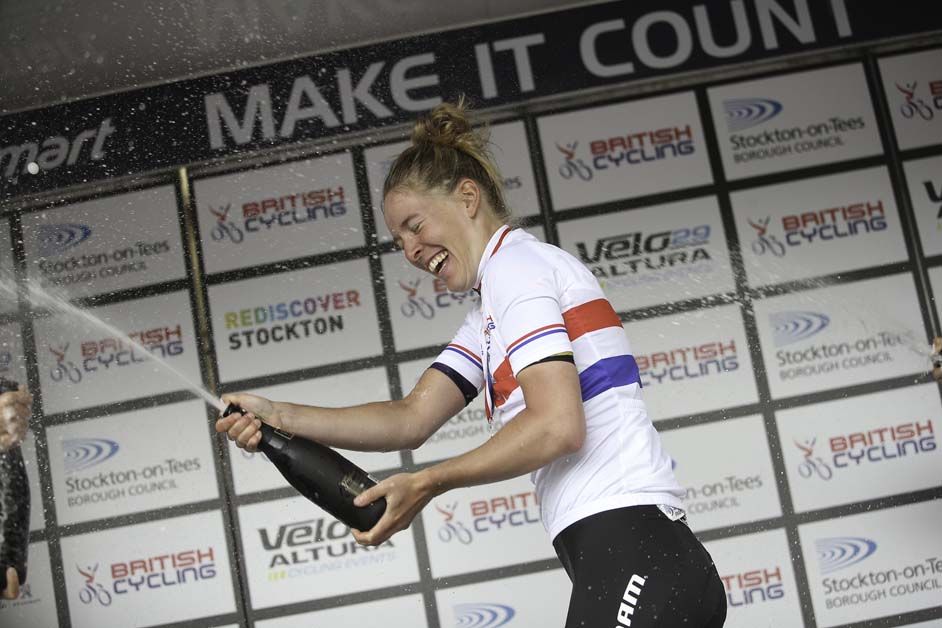 Hannah Barnes sprays the champagne