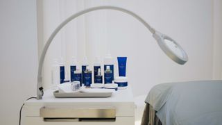 Augustinus Bader products beside bed at the brand's new spa at Lanserhof Clinic London