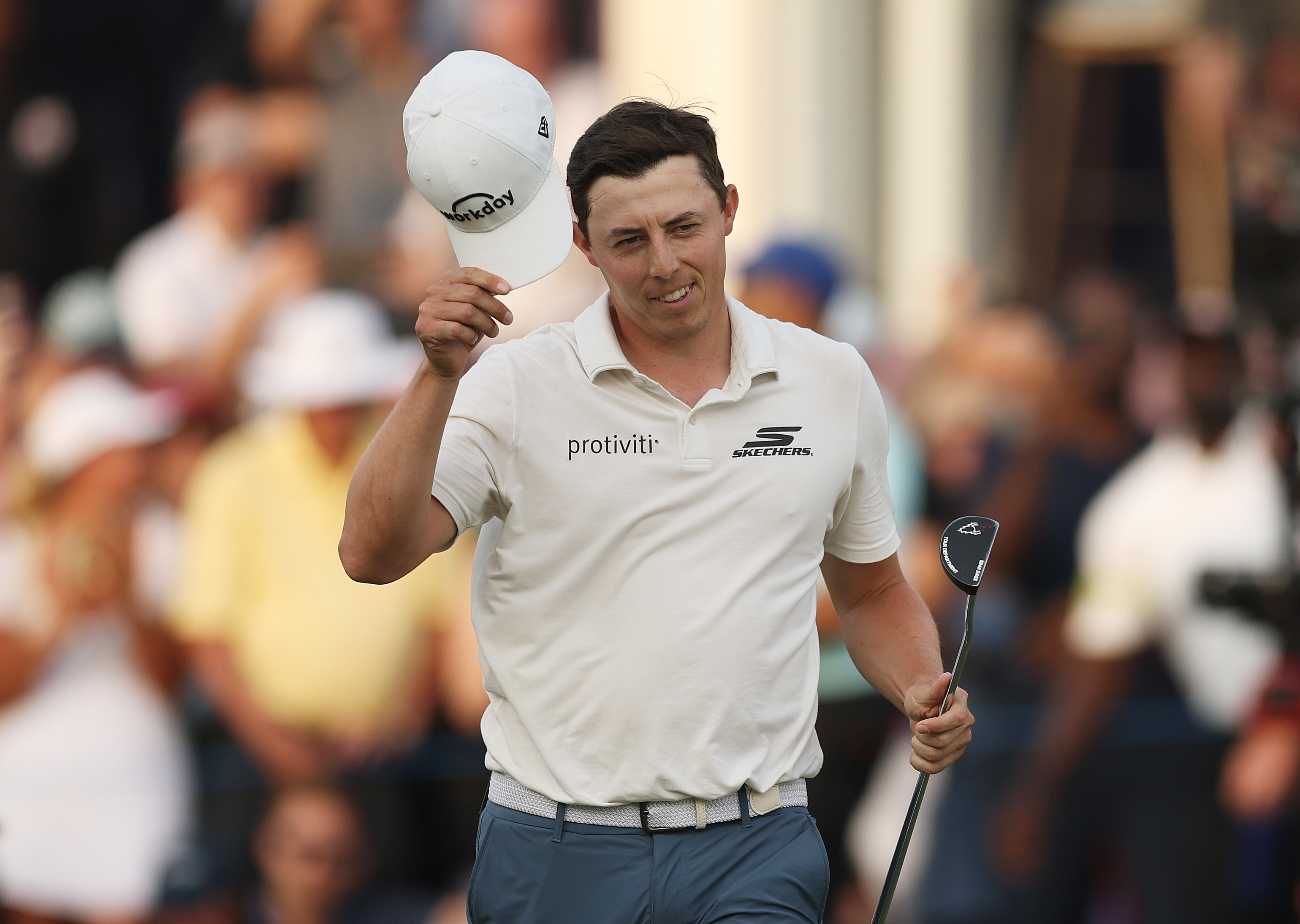 Matt Fitzpatrick removes his cap and walks off the green
