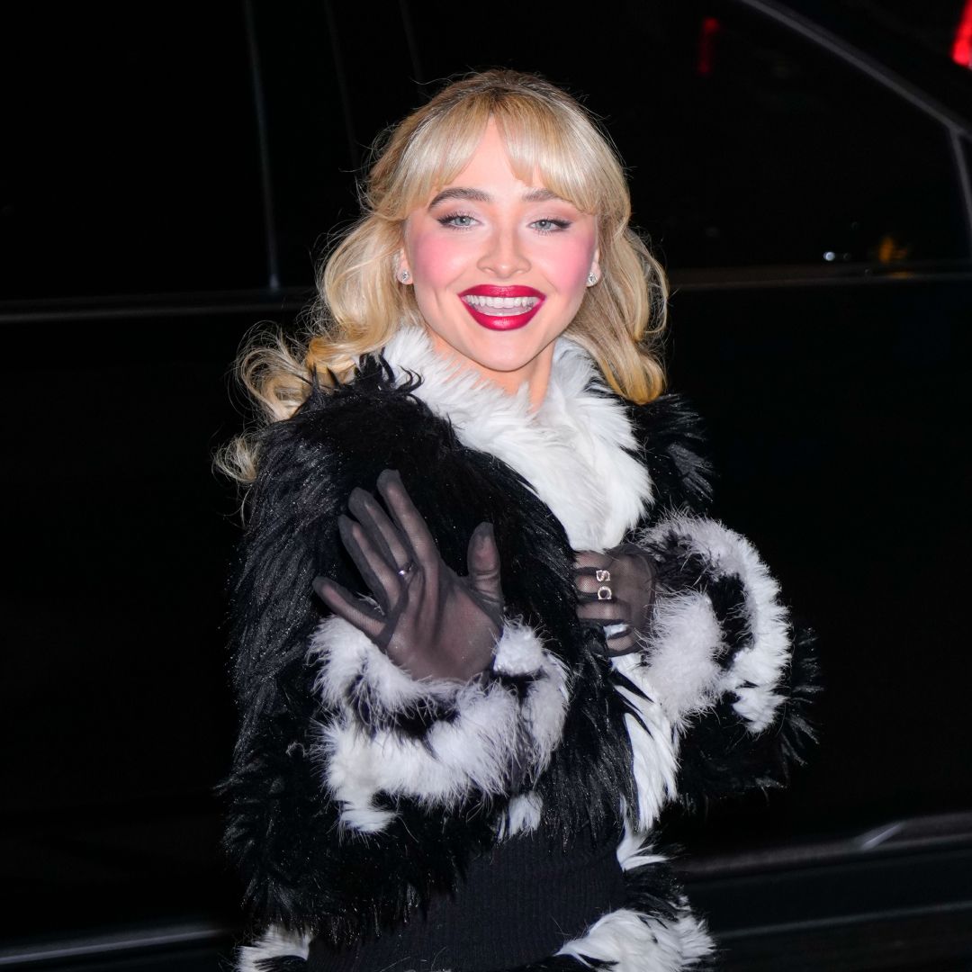 Sabrina Carpenter wearing red lipstick and a black and white fur coat 