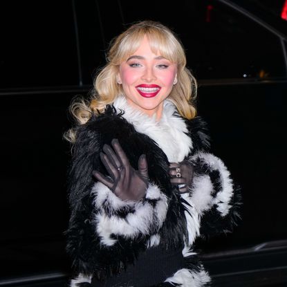 Sabrina Carpenter wearing red lipstick and a black and white fur coat