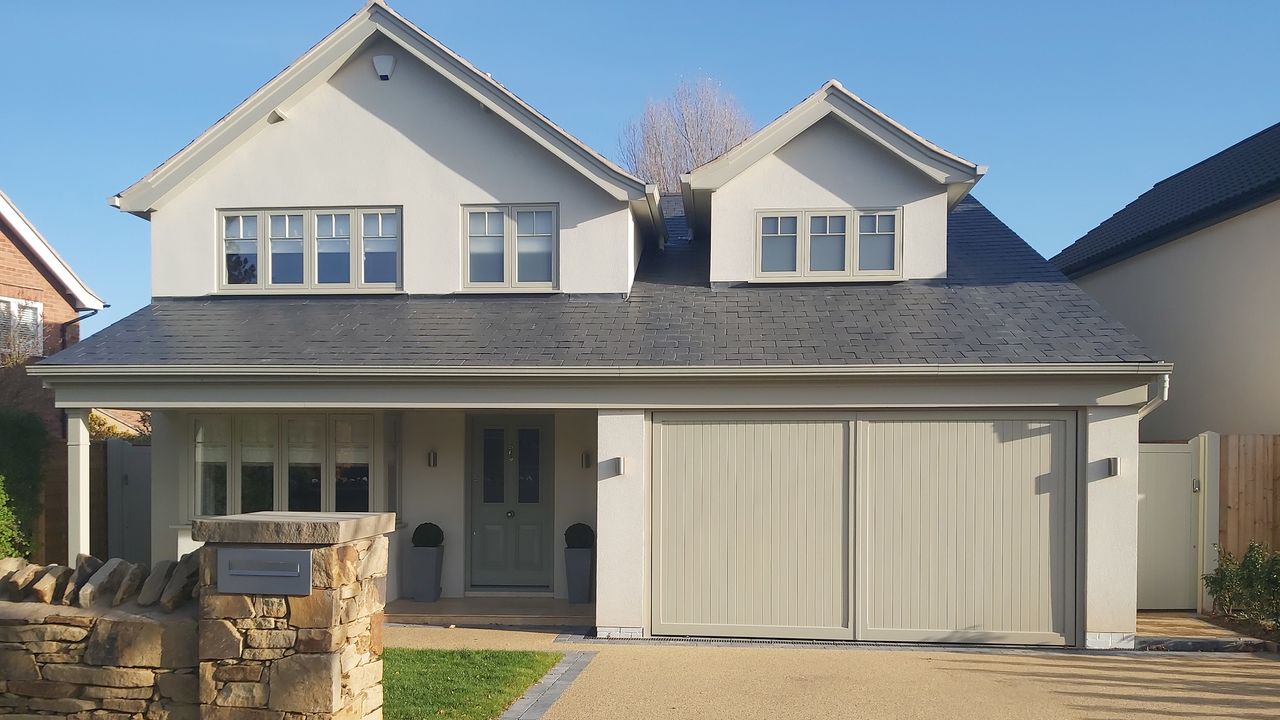 renovated 1970s house with integral garage and render