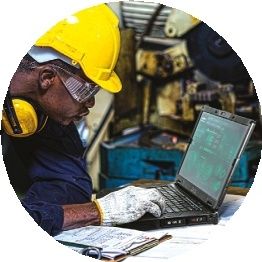 Construction worker typing on a rugged PC