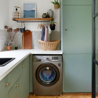 Green utility room with silver washing machine