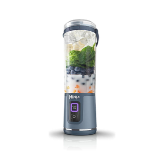 Ninja Blast Portable Blender with a blueberry smoothie in it on a white background