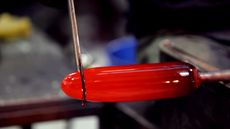 Shaping a piece of red glass