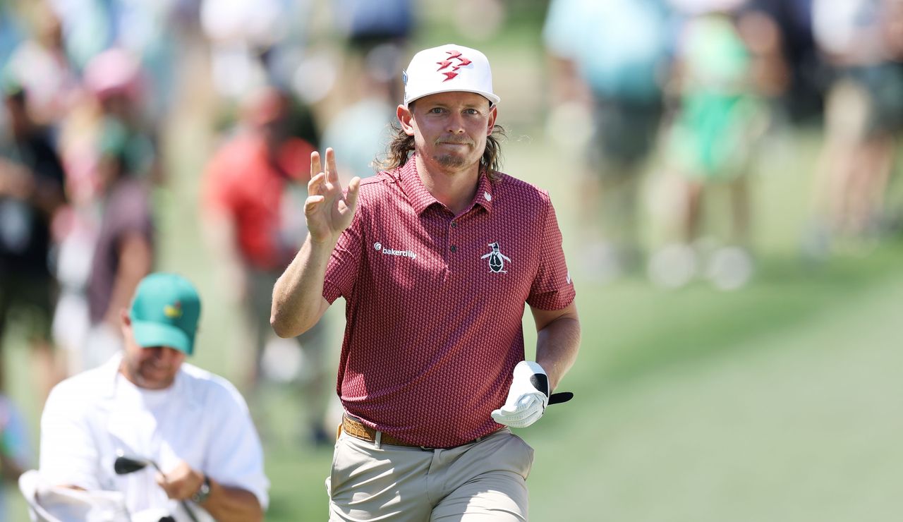 Cameron Smith waves to the crowd after holing an eagle shot